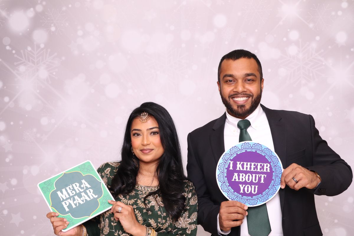 Guest holding custom prop sign at photo booth