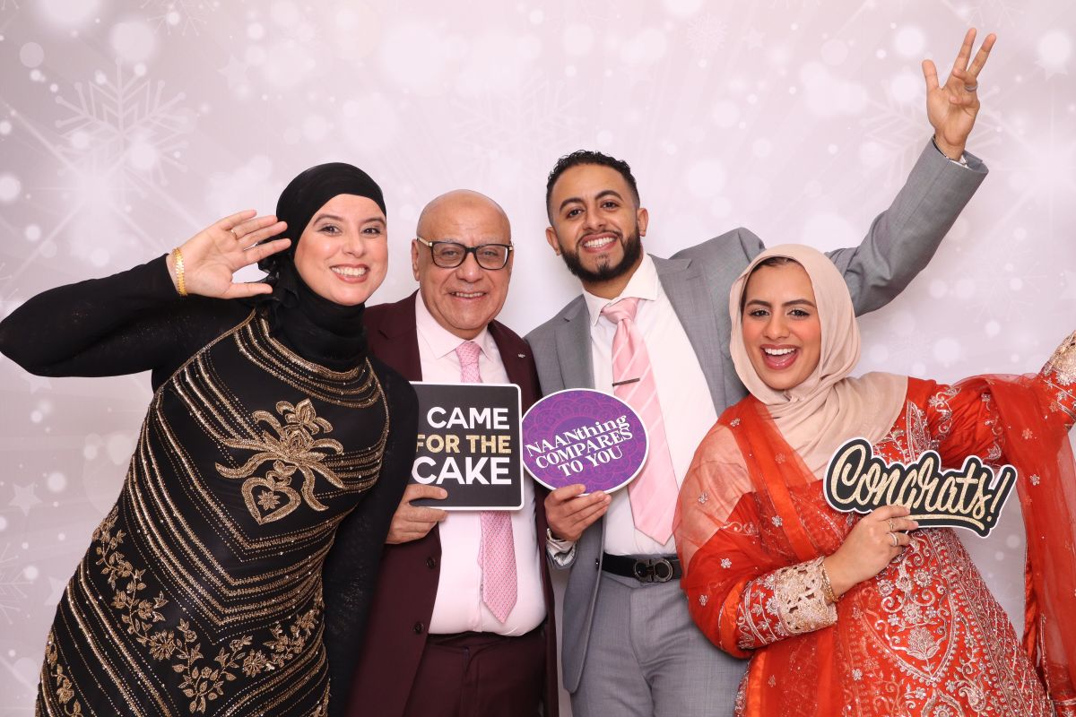 Family enjoying DSLR photo booth at celebration